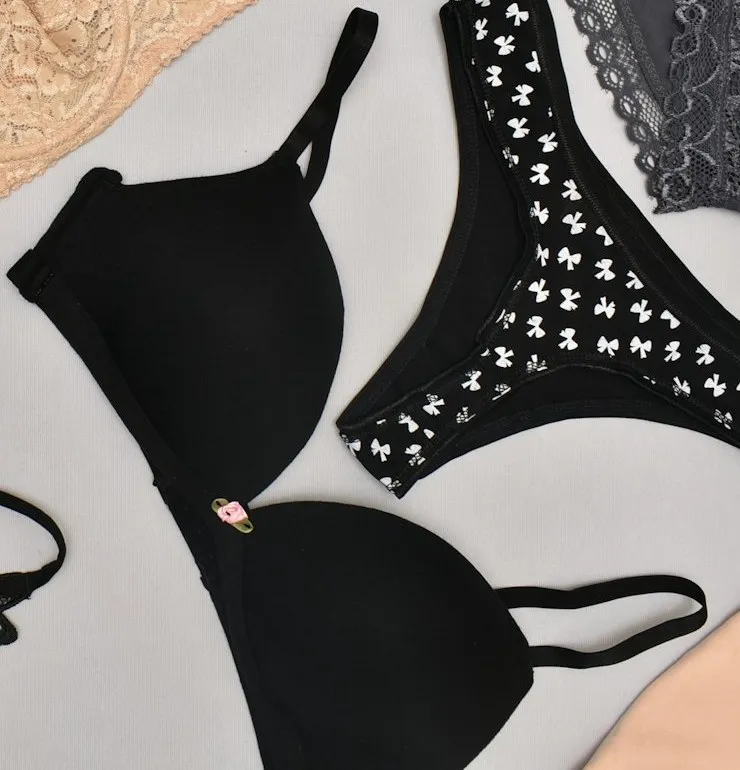 A black bra with smooth molded cups laid flat