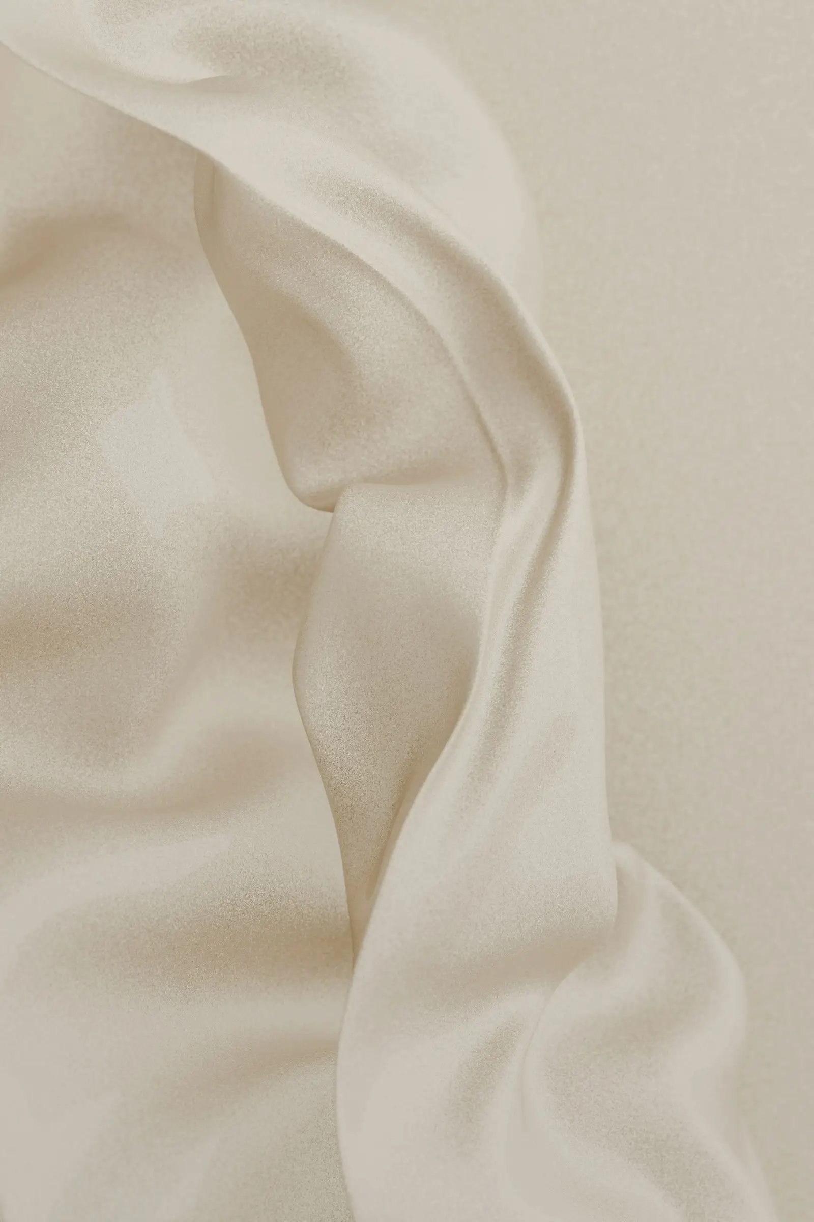 Smooth cream silk fabric in soft folds