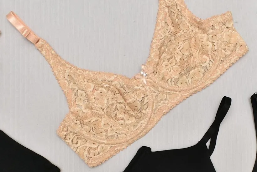 A nude lace underwired bra with unlined lace cups laid flat