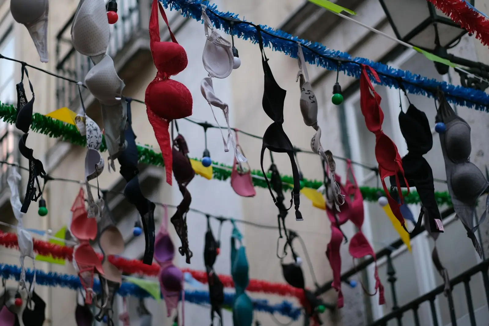 Rows of colorful bras hanging on strings