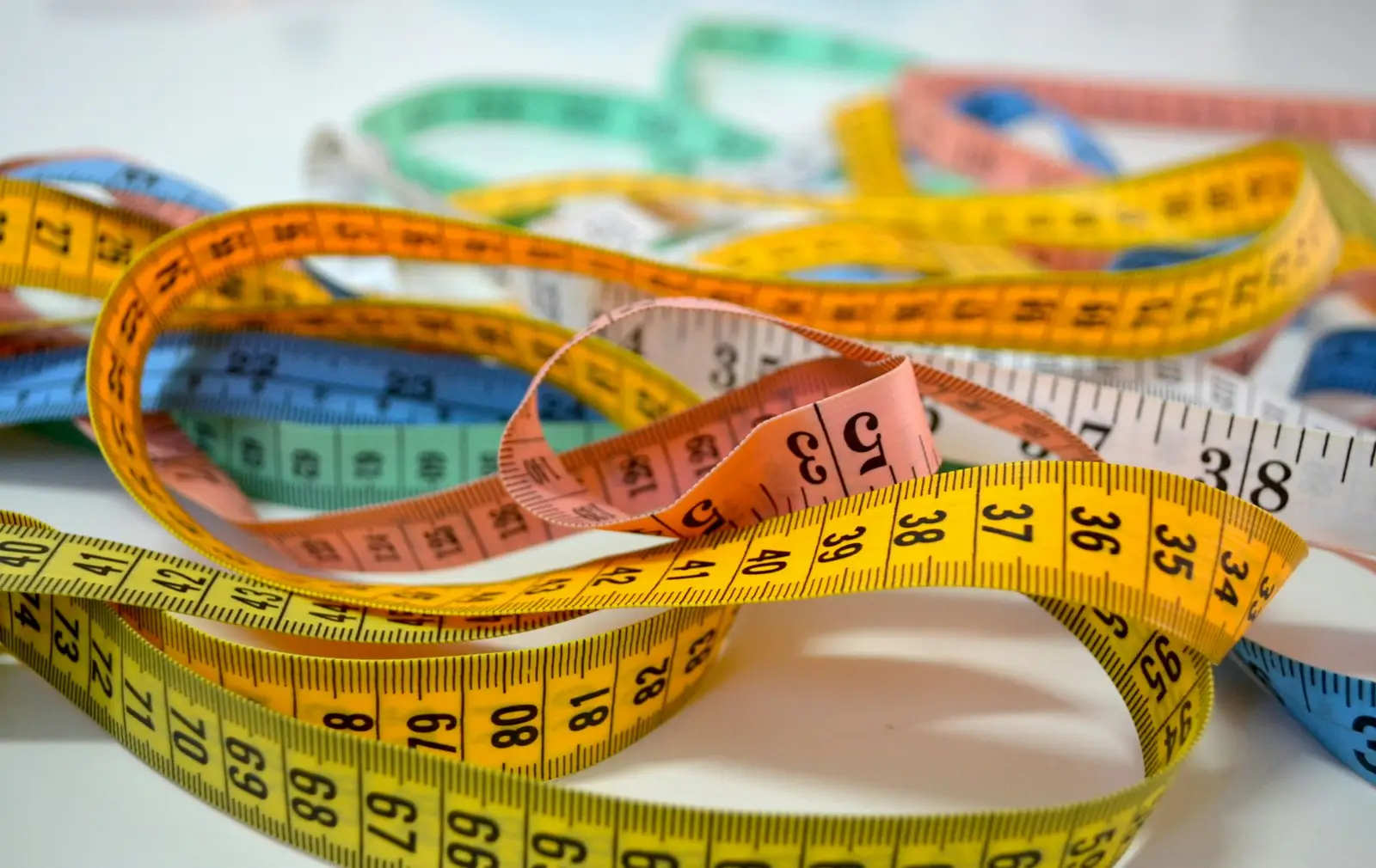 A tangle of colorful tailor’s measuring tapes