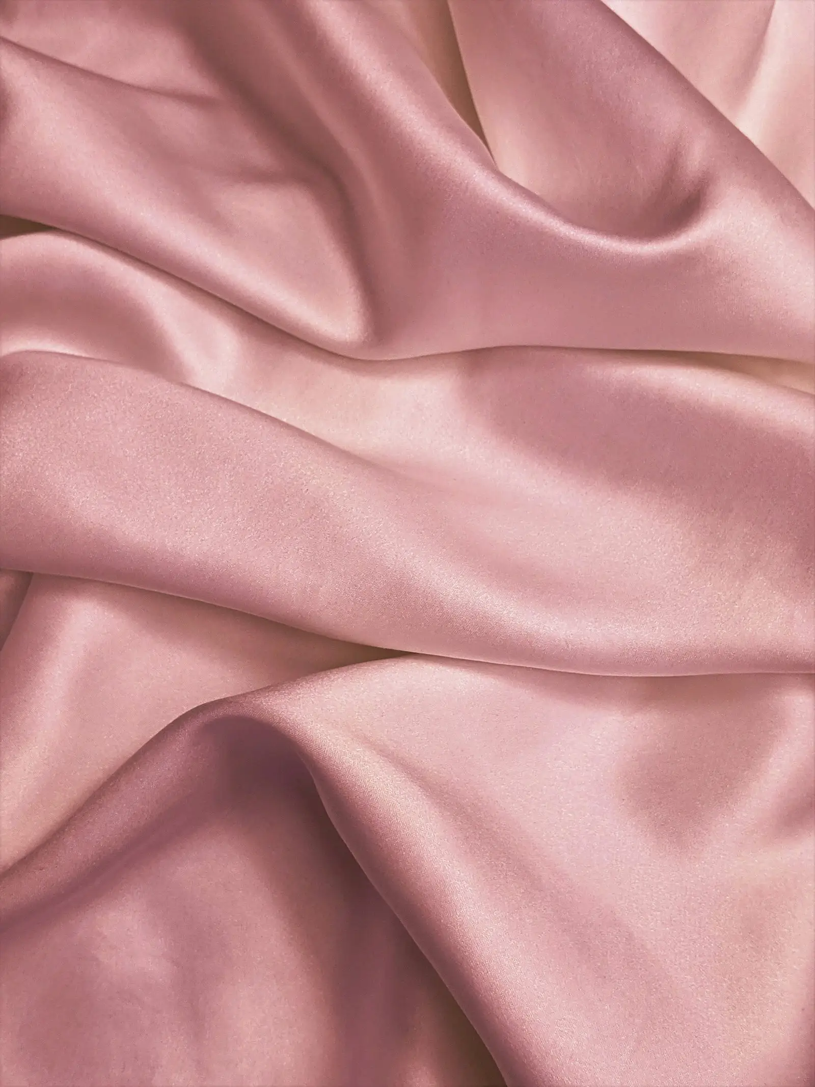 Soft folds of pink satin fabric