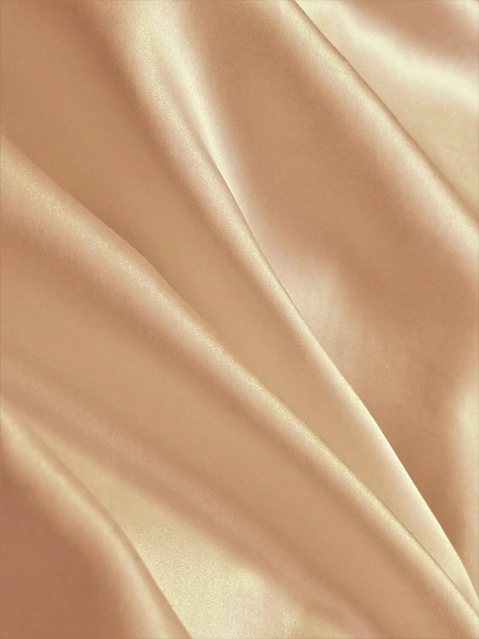 Folds of smooth champagne satin fabric