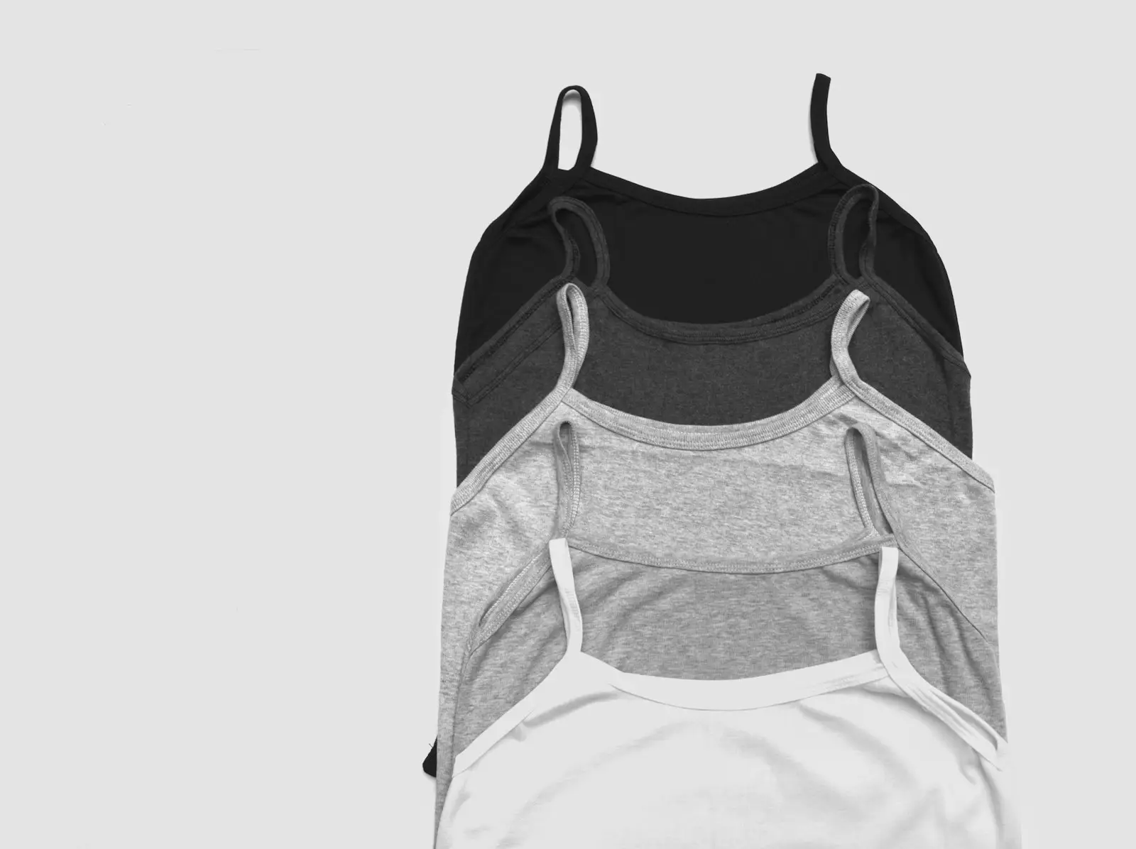 Camisole tops with thin straps hanging in a row
